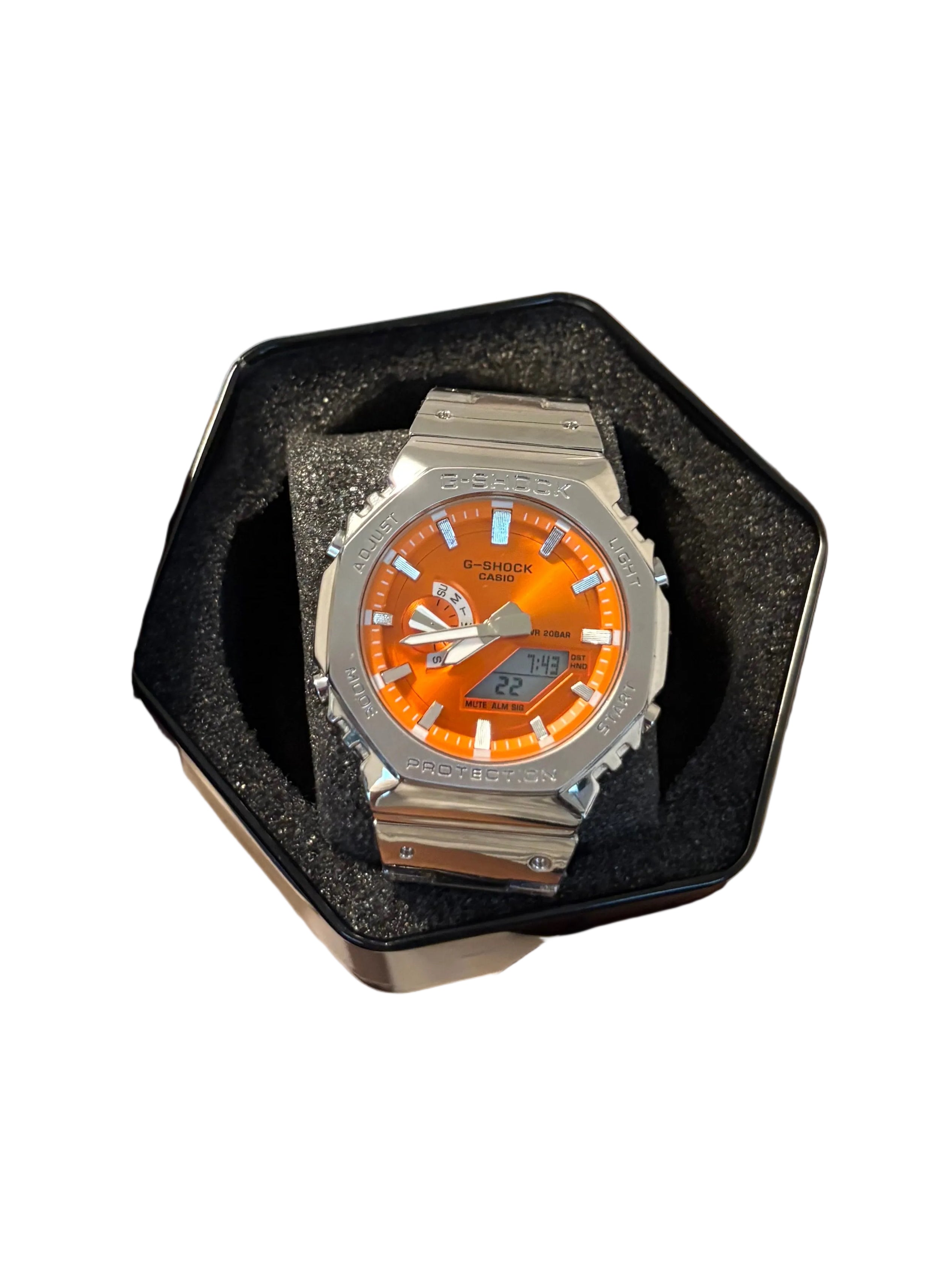 Silver and orange metal g shock